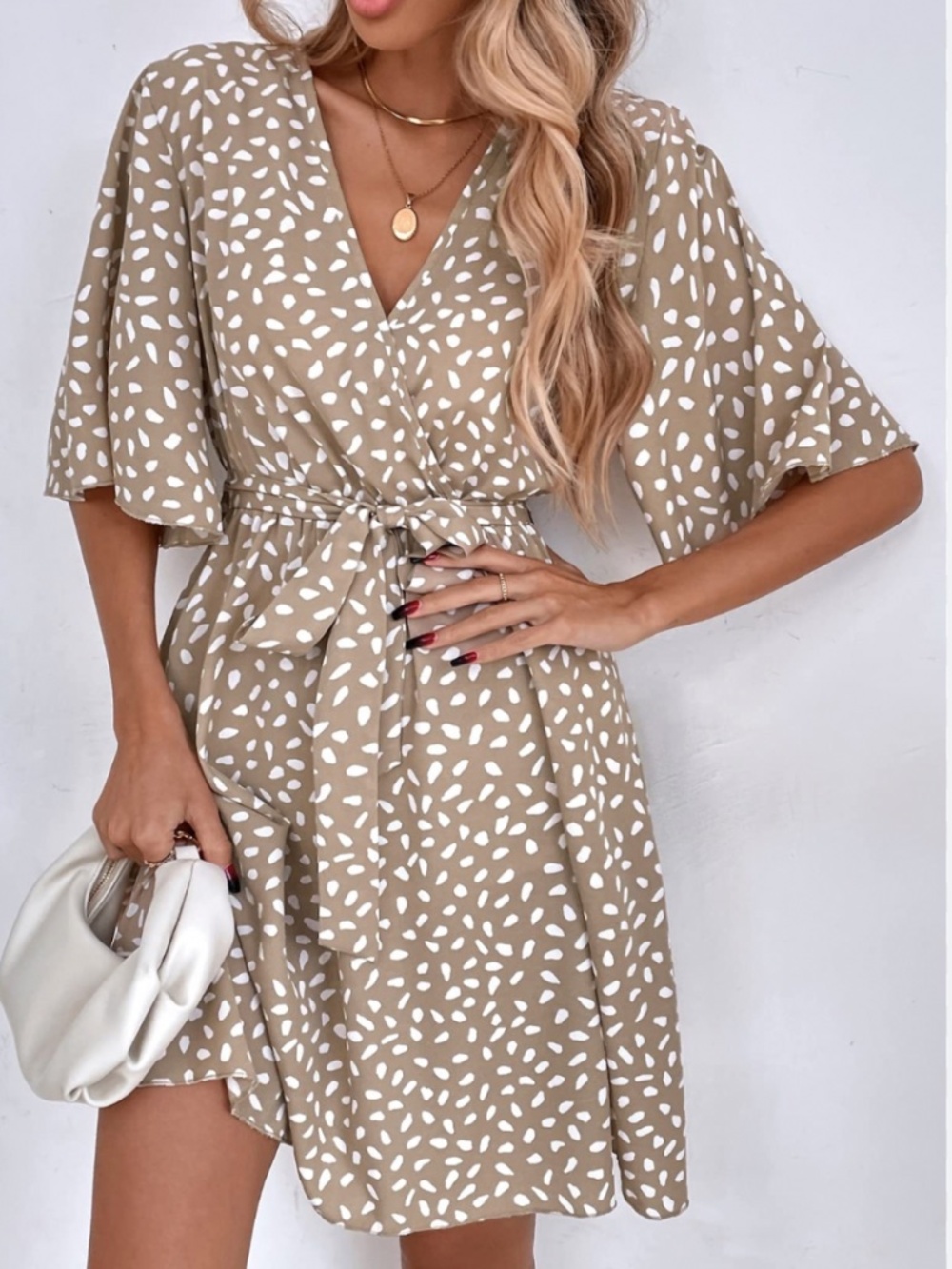 Chic wrap midi dress with V-neck. Beige base with white abstract spots. Tie wais